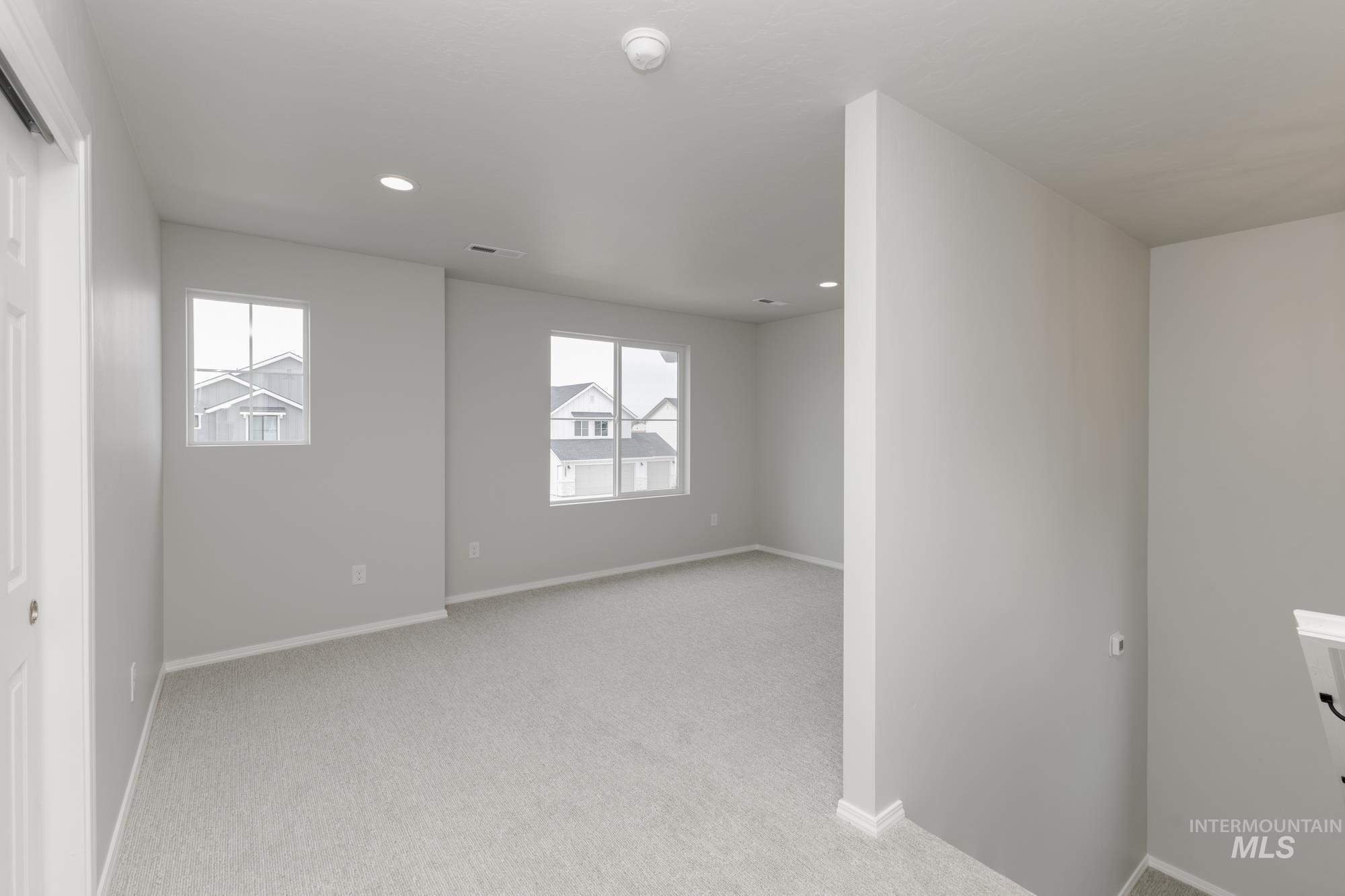 12842 Ropers Street Nampa, ID 83651 - Photo 16 of 29 Carpeted room featuring multiple windows, recessed lighting, and neutral wall paint