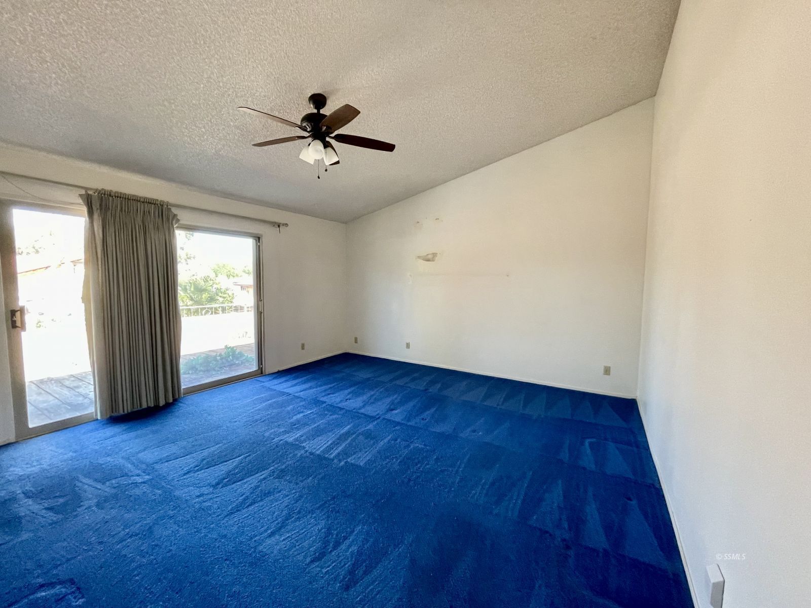 636 Mamie Street Ridgecrest, CA 93555 - Photo 10 of 39 an empty room with wooden floor fan and windows