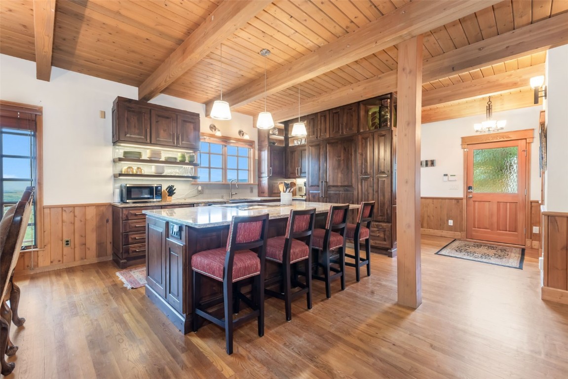 2300 Glacier Ridge Steamboat Springs, CO 80487 - Photo 11 of 50 a kitchen with stainless steel appliances a dining table chairs and wooden floor