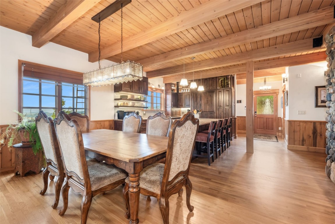 2300 Glacier Ridge Steamboat Springs, CO 80487 - Photo 13 of 50 a dining room with wooden floor a chandelier a glass table and chairs