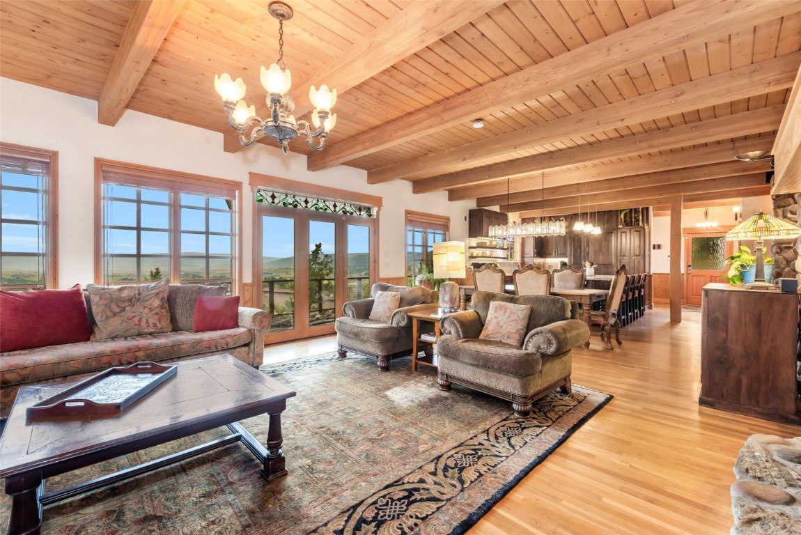 2300 Glacier Ridge Steamboat Springs, CO 80487 - Photo 16 of 50 a living room with furniture a chandelier and a dining table