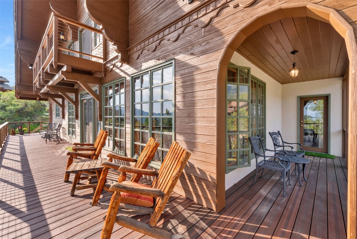 2300 Glacier Ridge Steamboat Springs, CO 80487 - Photo 20 of 50 a view of a patio with table and chairs and wooden floor