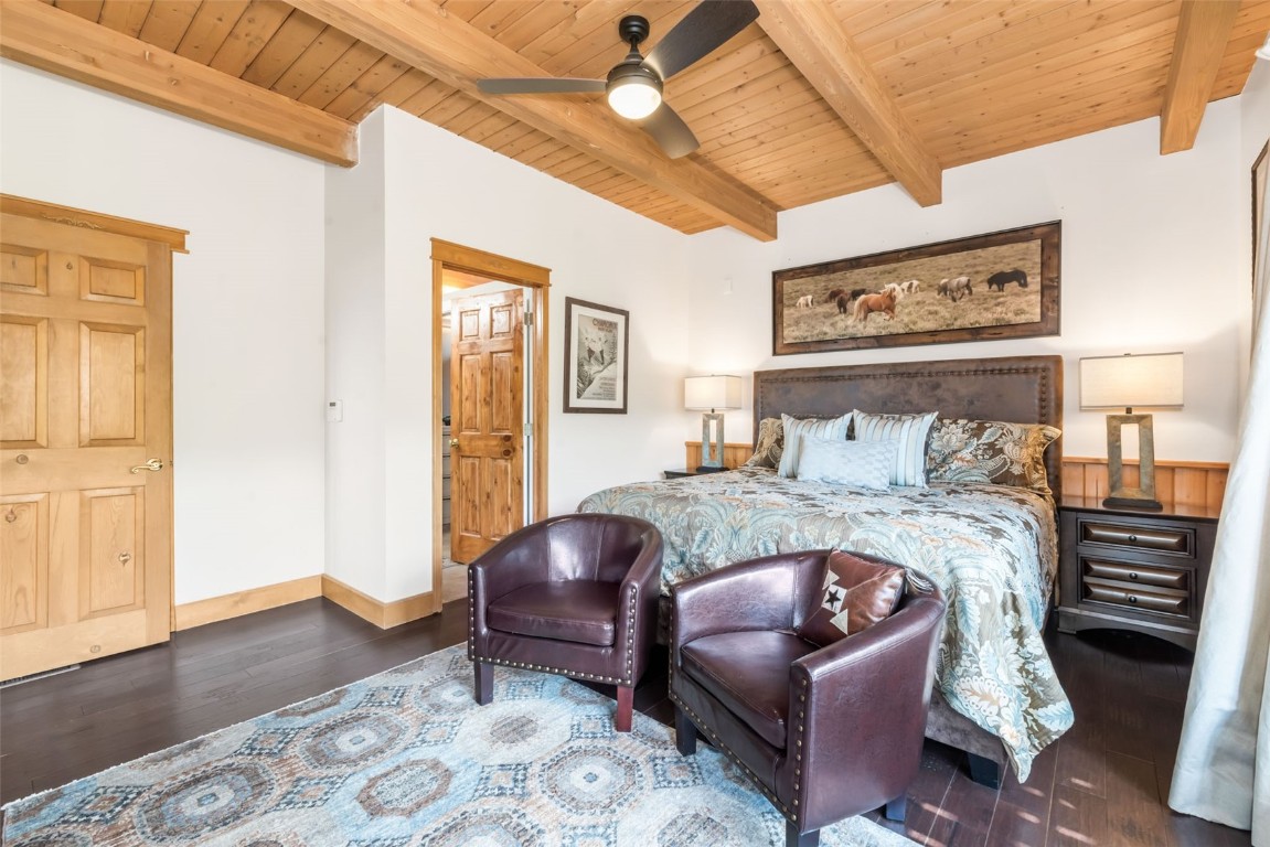 2300 Glacier Ridge Steamboat Springs, CO 80487 - Photo 22 of 50 a bedroom with a bed and wooden floor
