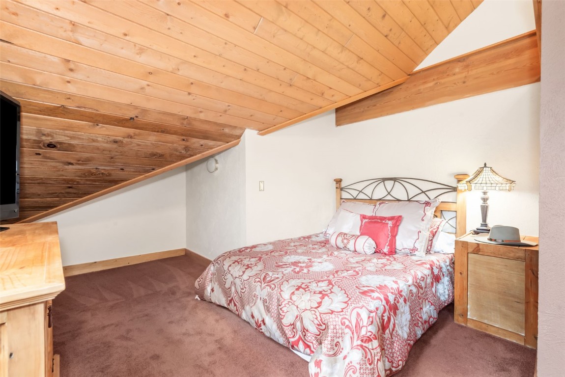 2300 Glacier Ridge Steamboat Springs, CO 80487 - Photo 34 of 50 a bedroom with a bed and a night stand