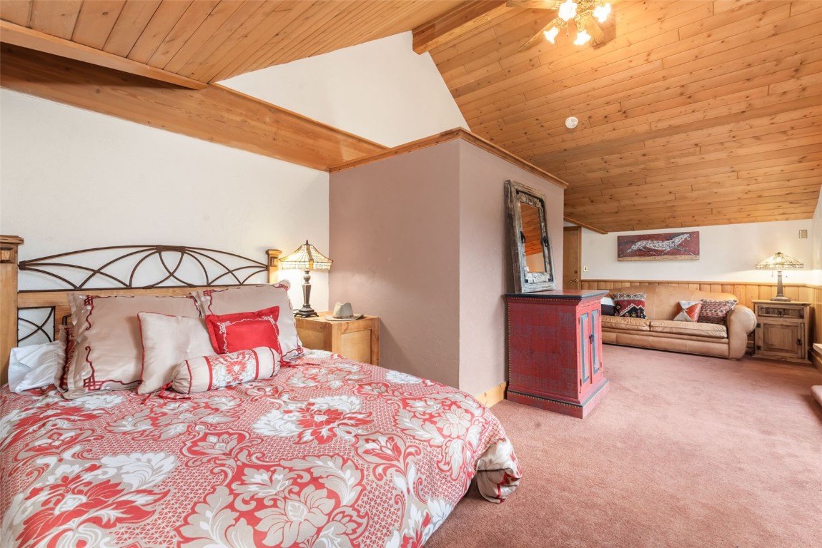 2300 Glacier Ridge Steamboat Springs, CO 80487 - Photo 35 of 50 a bedroom with a bed and a chandelier