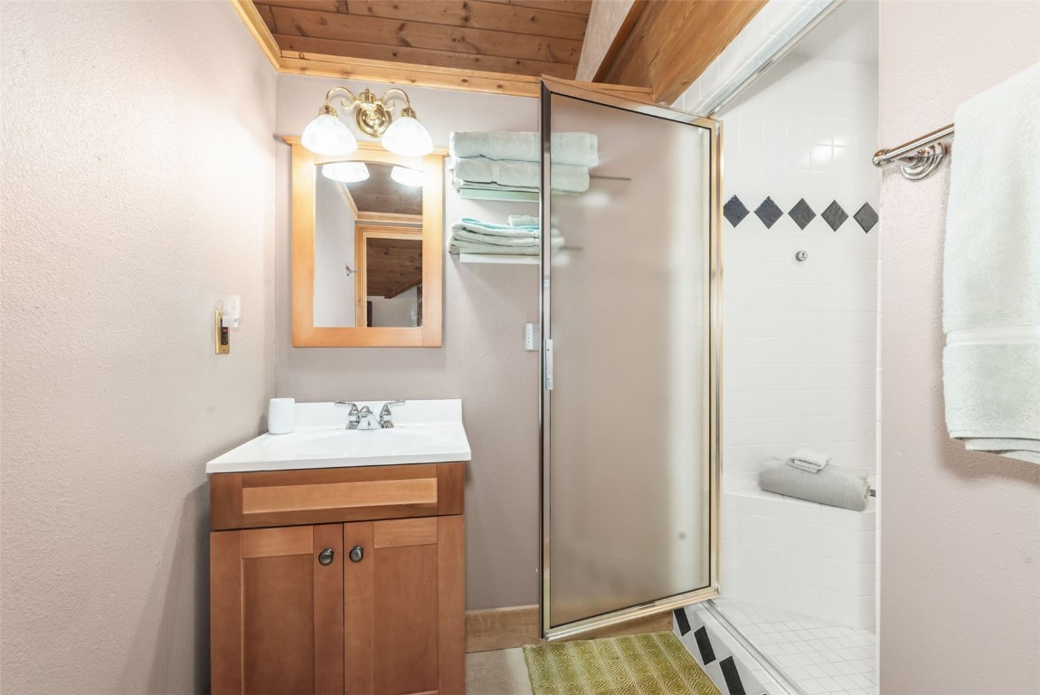 2300 Glacier Ridge Steamboat Springs, CO 80487 - Photo 36 of 50 a bathroom with a sink and mirror