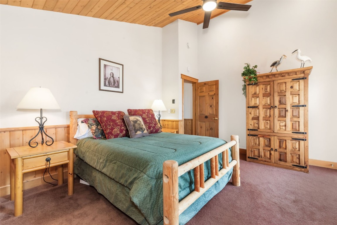 2300 Glacier Ridge Steamboat Springs, CO 80487 - Photo 41 of 50 a bedroom with a bed and a chandelier