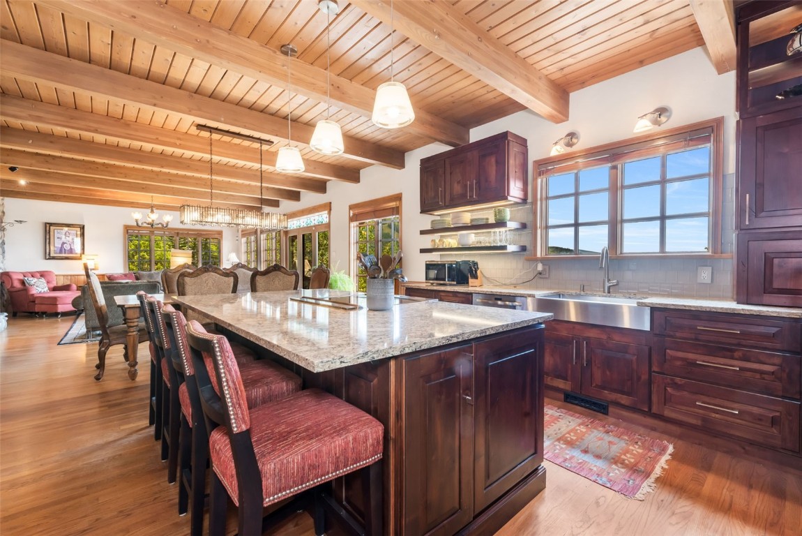 2300 Glacier Ridge Steamboat Springs, CO 80487 - Photo 7 of 50 a kitchen with a table chairs and wooden cabinets