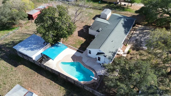 an aerial view of a house with a yard