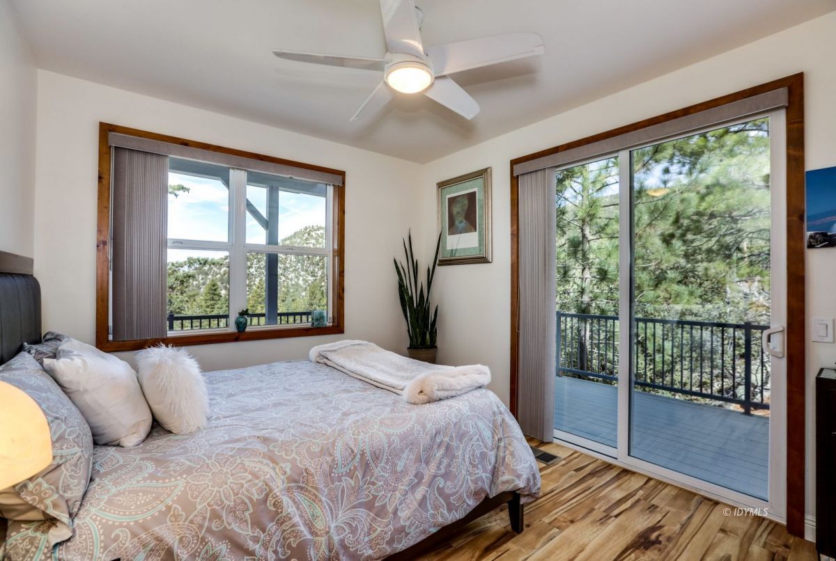25126 Cougar Road Idyllwild, CA 92549 - Photo 28 of 63 a bedroom with a large bed and a large window