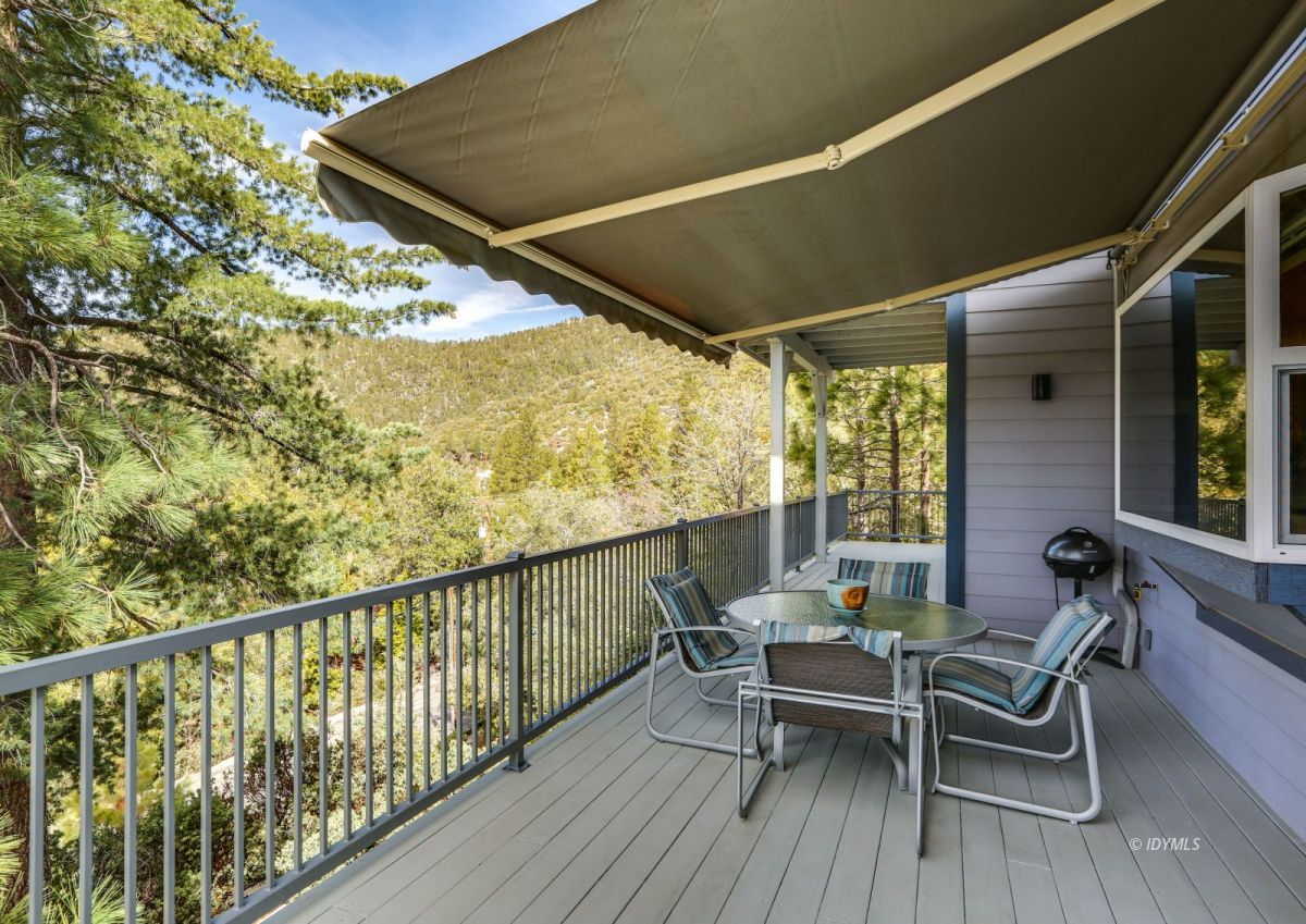 25126 Cougar Road Idyllwild, CA 92549 - Photo 38 of 63 a balcony with wooden floor table and chairs