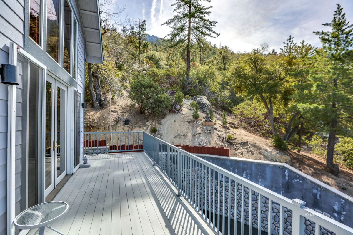25126 Cougar Road Idyllwild, CA 92549 - Photo 40 of 63 a view of a balcony with wooden floor and fence