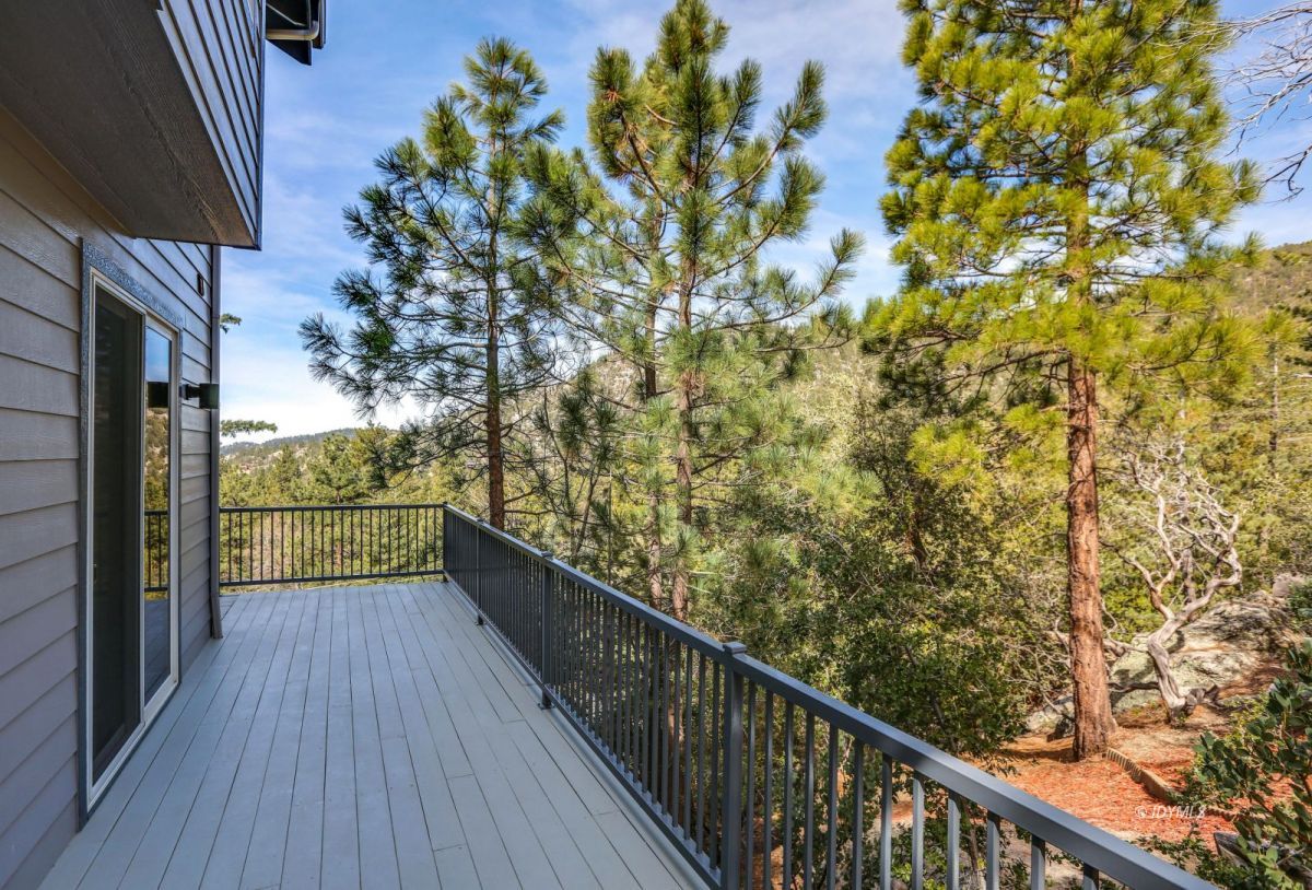 25126 Cougar Road Idyllwild, CA 92549 - Photo 47 of 63 a view of balcony with wooden floor and fence