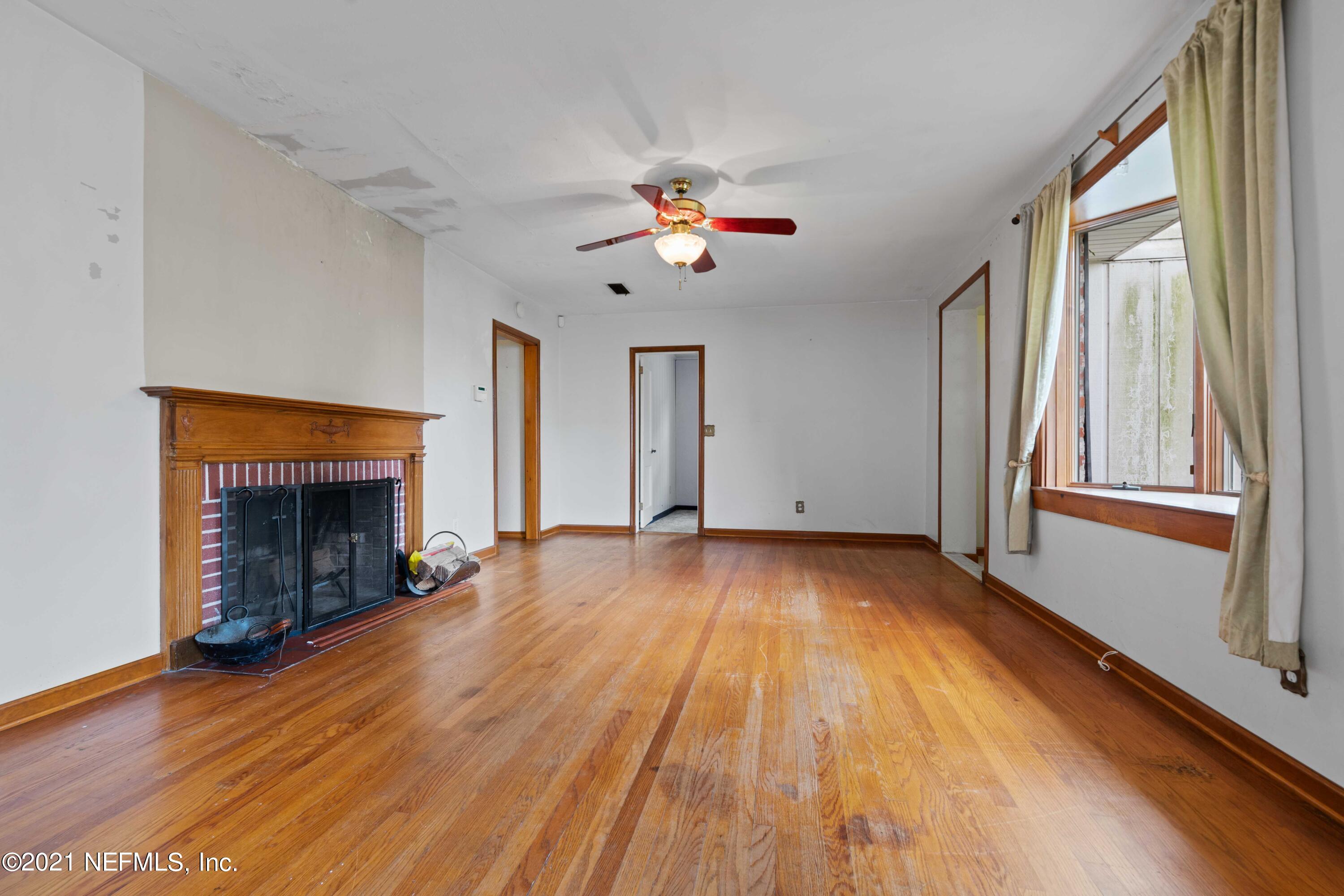 1624 Mayfair Road Jacksonville, FL 32207 - Photo 4 of 23 wooden floor in an empty room with a window