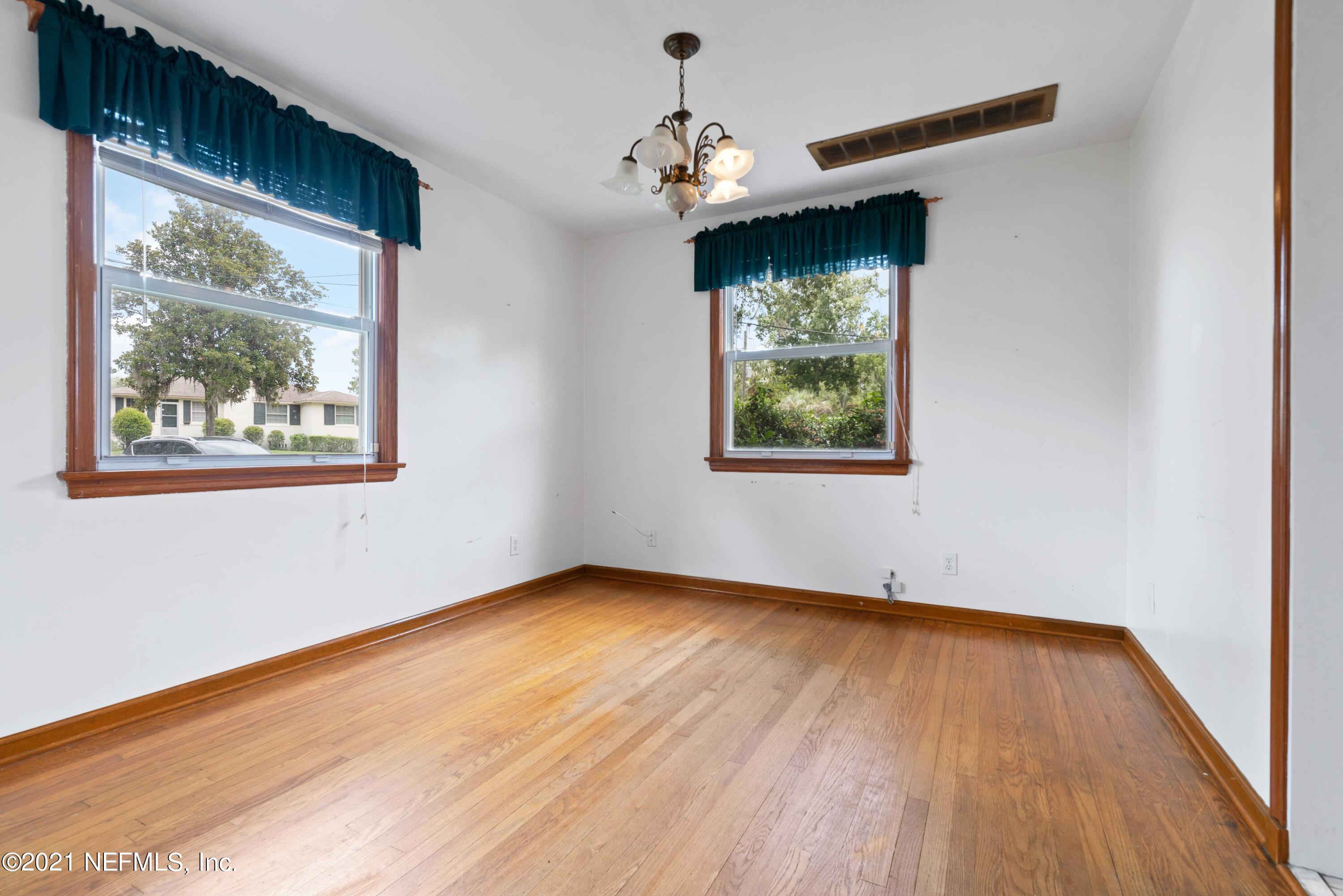 1624 Mayfair Road Jacksonville, FL 32207 - Photo 6 of 23 a view of an empty room with wooden floor and a window