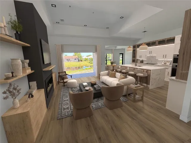 a kitchen with stainless steel appliances kitchen island granite countertop a dining table chairs and a refrigerator