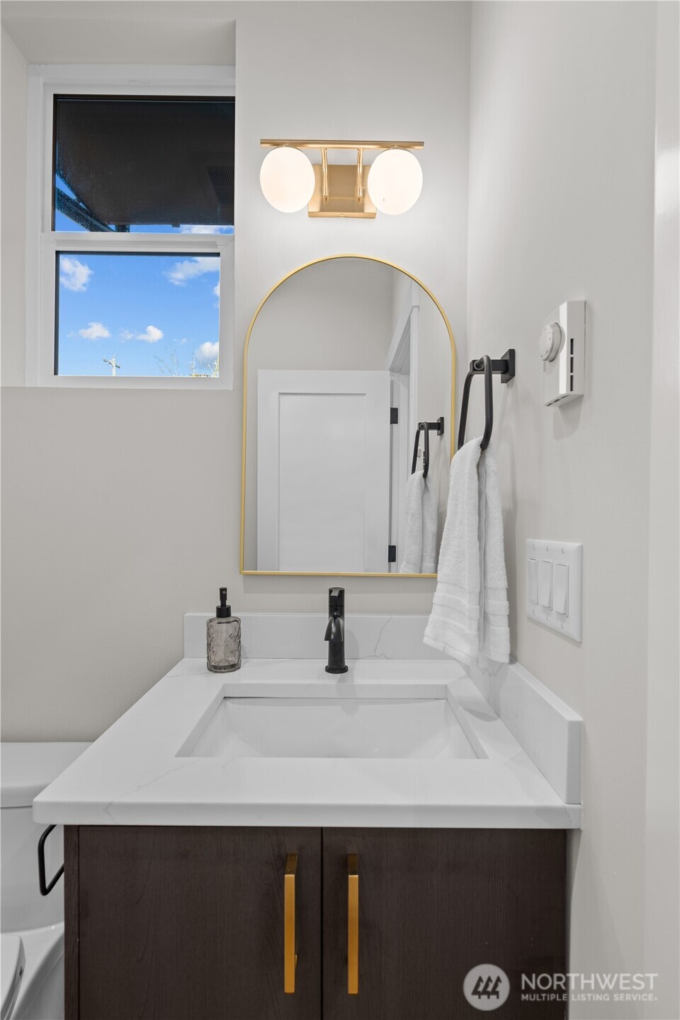9230 22nd Avenue Southwest Seattle, WA 98106 - Photo 13 of 26 a bathroom with a sink and a mirror