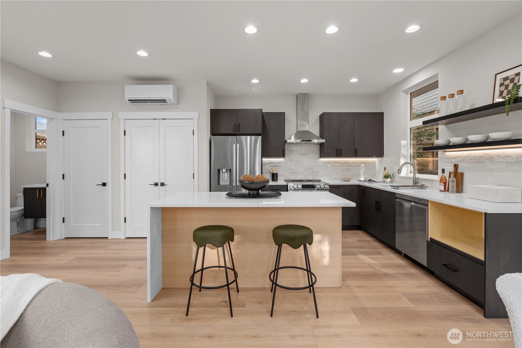 9230 22nd Avenue Southwest Seattle, WA 98106 - Photo 7 of 26 a kitchen with stainless steel appliances granite countertop a table chairs sink and microwave