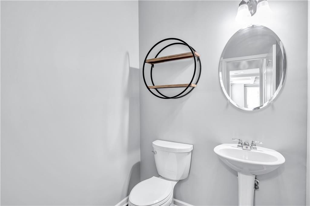 330 Avalon Square Fairburn, GA 30213 - Photo 12 of 52 a bathroom with a toilet a sink and a mirror
