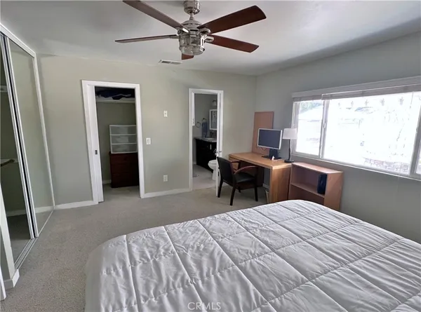 an empty room with wooden floor and a fireplace