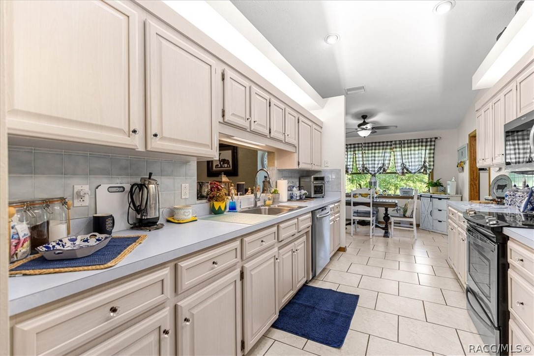 2964 South Cygnet Terrace Inverness, FL 34450 - Photo 13 of 67 a kitchen with stainless steel appliances granite countertop a sink and cabinets