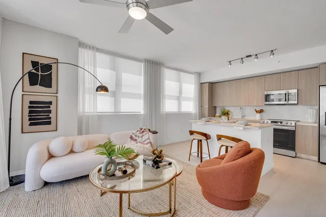 a living room with furniture kitchen and a window