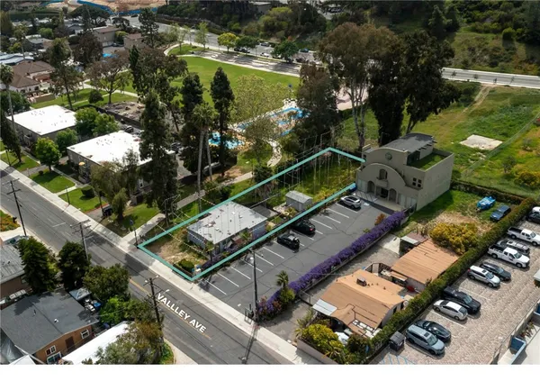 an aerial view of a residential houses with outdoor space