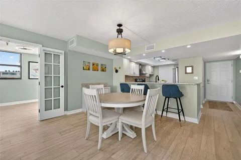 a view of a dining room with furniture and wooden floor