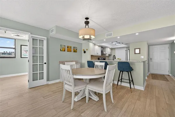 a view of a dining room with furniture and wooden floor