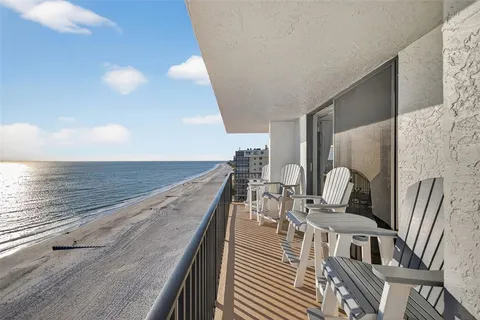 a view of balcony with two chairs and wooden floor