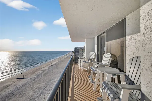 a view of balcony with two chairs and wooden floor