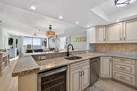 a kitchen with granite countertop a sink and cabinets