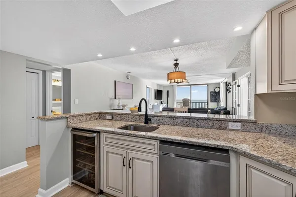 a kitchen with stainless steel appliances granite countertop a sink stove and cabinets