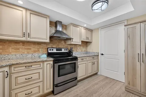 a kitchen with stainless steel appliances granite countertop a stove and a sink
