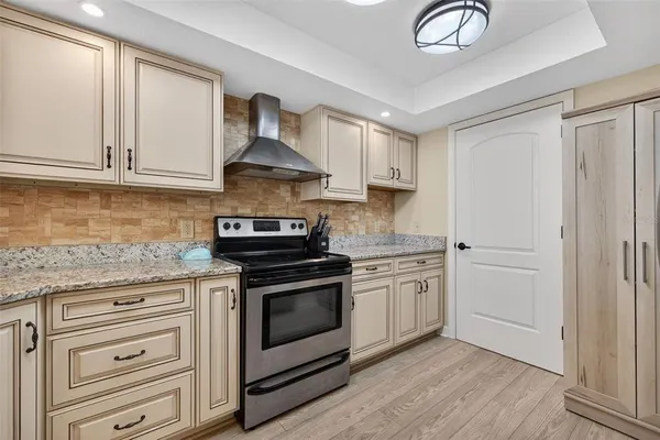 a kitchen with stainless steel appliances granite countertop a stove and a sink