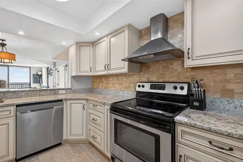 a kitchen with white cabinets and appliances