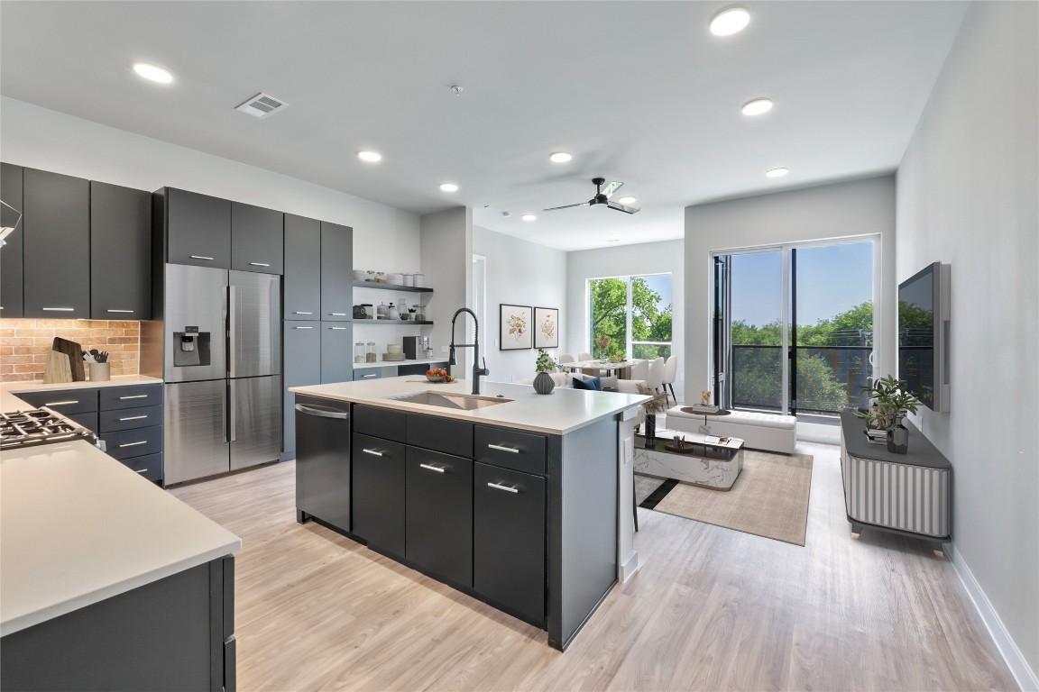4510 Terry-O Lane, Unit 345 Austin, TX 78745 - Photo 1 of 15 a large kitchen with kitchen island a large counter top space a sink stainless steel appliances and windows