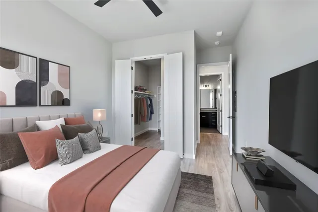 a bedroom with a bed and a flat screen tv