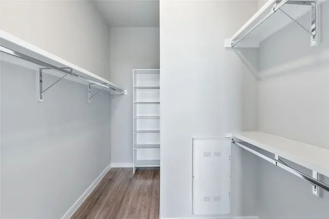 a view of walk in closet with empty racks