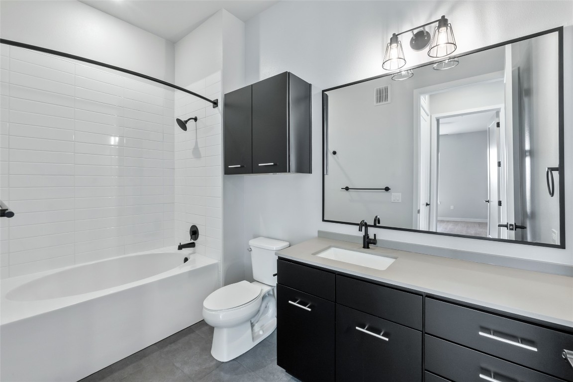 4510 Terry-O Lane, Unit 345 Austin, TX 78745 - Photo 13 of 15 a bathroom with a bathtub shower sink vanity and toilet
