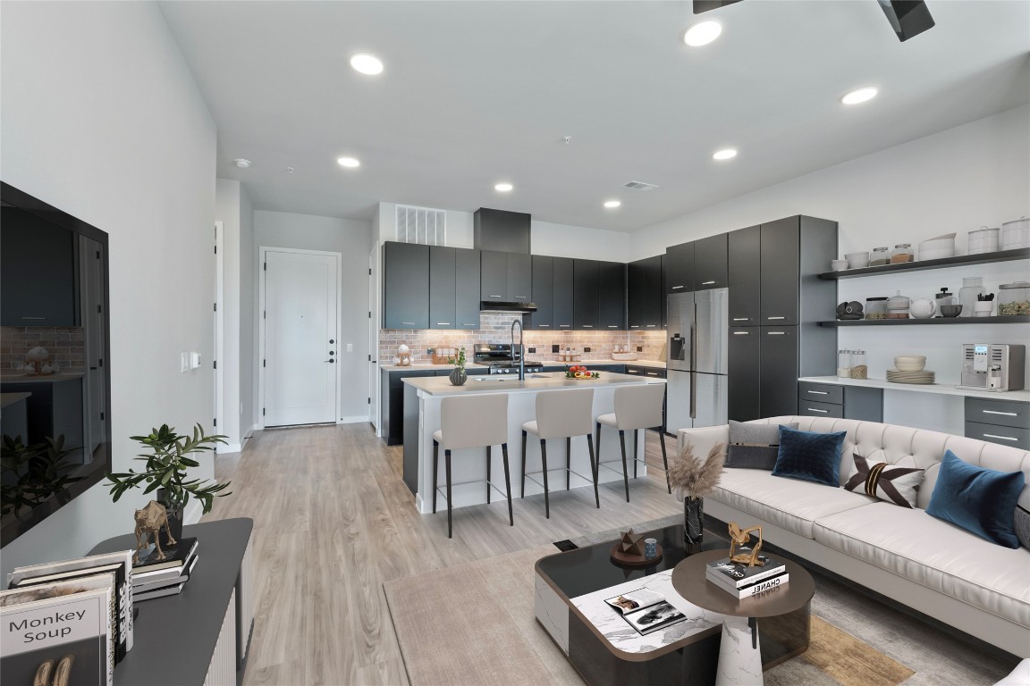 4510 Terry-O Lane, Unit 345 Austin, TX 78745 - Photo 4 of 15 a living room with furniture and a dining table with kitchen view