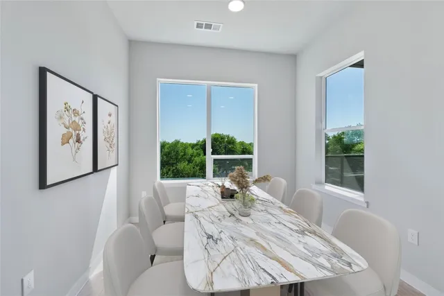 a living room with furniture large window and wooden floor