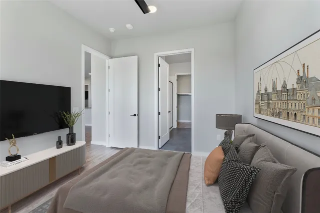 a bedroom with furniture and a flat screen tv