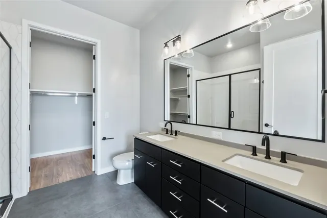 a spacious bathroom with a double vanity sink mirror double and shower