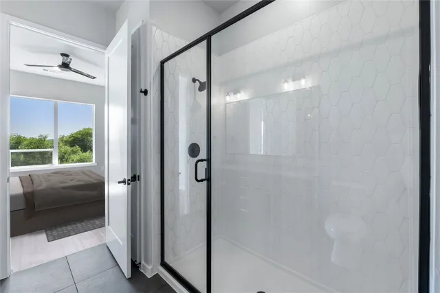 a bathroom with a glass shower door