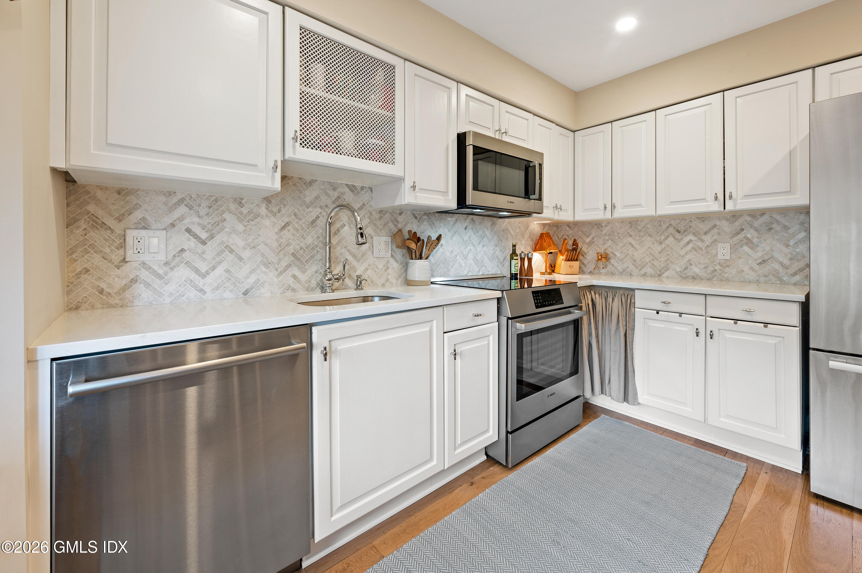 115 River Road, Unit 3 Cos Cob, CT 06807 - Photo 27 of 40 a kitchen with a sink stove and microwave