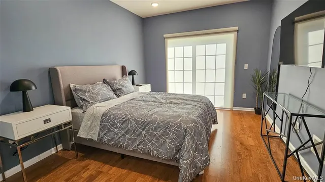 a bed sitting in a spacious bedroom next to a window