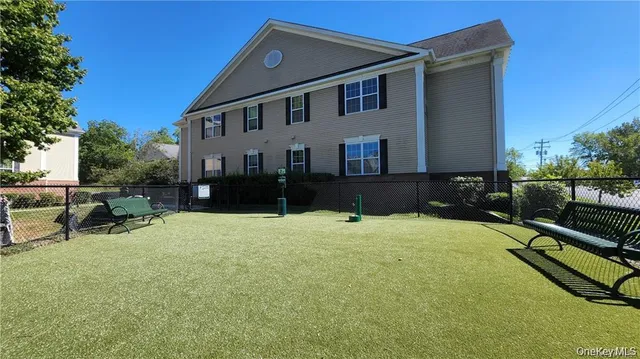 a backyard of a house with table and chairs