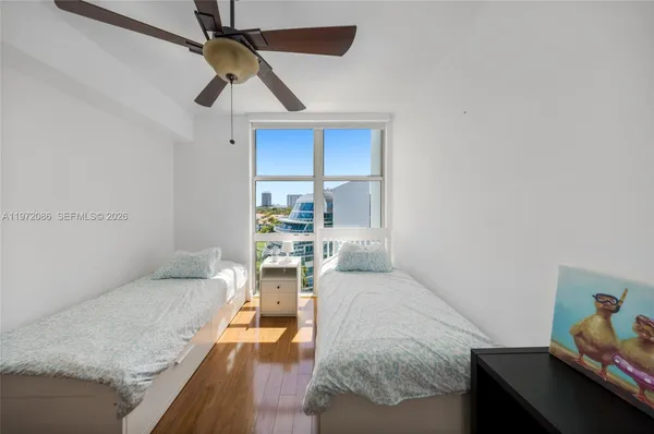 a living room with furniture and a ceiling fan