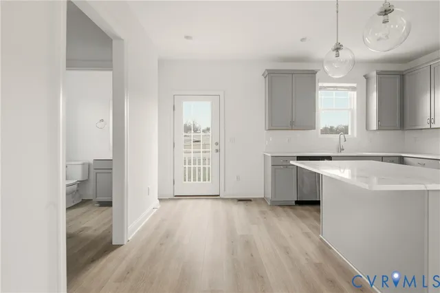 a view of a kitchen with a sink and a large window
